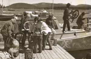 people loading spinning wheels on boat
